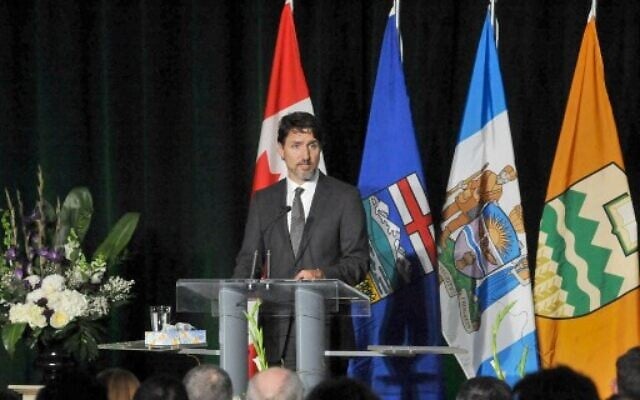 Canadian Prime Minister Justin Trudeau speaks at a memorial service for the victims of the Ukrainian Airlines flight PS752 crash in Iran at the Saville Community Sports Centre in Edmonton January 12, 2020. (Photo by Walter Tychnowicz / AFP) Canadian Prime Minister Justin Trudeau speaks at a memorial service for the victims of the Ukrainian Airlines flight PS752 crash in Iran at the Saville Community Sports Centre in Edmonton January 12, 2020. (Photo by Walter Tychnowicz / AFP)