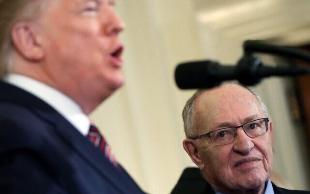 Professor Alan Dershowitz (right) listens to US President Donald Trump speak during a Hanukkah Reception in the East Room of the White House, December 11, 2019. (Mark Wilson/Getty Images North America/AFP)