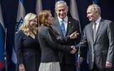 Prime Minister Benjamin Netanyahu, center, smile as Yaffa Issachar, second left, the mother of Naama Issachar, who is imprisoned in Russia, shakes hands with Russian President Vladimir Putin, right, in Jerusalem on January 23, 2020, ahead of the World Holocaust Forum. (Heidi Levine/Pool/AFP)