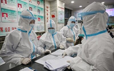 Medical staff wear protective clothing to help stop the spread of a deadly virus which began in the city, work at the Wuhan Red Cross Hospital in Wuhan on January 25, 2020. (Hector Retamal/)