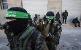 Members of the Hamas terror group's armed wing rest on a sidewalk during a patrol in Khan Younis in the southern Gaza Strip on January 26, 2020. (Said Khatib/AFP)