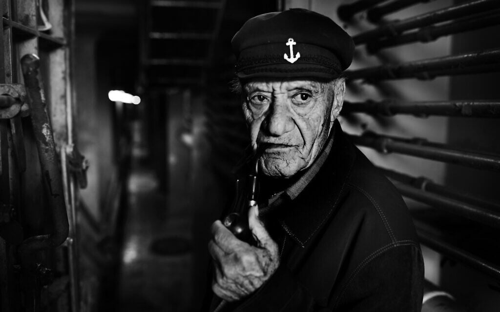Yossi Weiss, 82 years old, was born in 1937 in Bratislava, Slovakia. He was transferred to Zilina camp in 1941, and from there to the Novaky camp, both in Slovakia. His father was killed in the camps and Yossi was 5 when he last saw him. He and his mother and fled to the forests and lived in hiding in the forests with the partisans, suffering cold and extreme hunger. After the war they returned to Topolcany where they lived in great poverty, moving from place to place. At the age of 11, he was separated again from his mother who he never saw again. He immigrated to Israel alone and enlisted to the Israeli Navy at the age of 17 and spent 64 years at sea, and only stopped sailing in 2018, last year. Yossi Weiss is married to Michal and they have 4 children and live in Zichron Yaakov. Photographed on a ship in Haifa port in May 2019 (Eldad Rafaeli/The Lonka Project)
