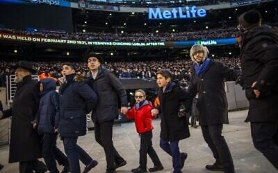 Orthodox Jews sing and dance during the 13th Siyum HaShas, a celebration marking the completion of the Daf Yomi, at the MetLife Stadium on January 1, 2020 in East Rutherford, New Jersey. Security was tightened at the event, where the Talmud is read in its entirety, after a rise in anti-Semitic incidents in the area.  ( Eduardo Munoz Alvarez/Getty Images/AFP)