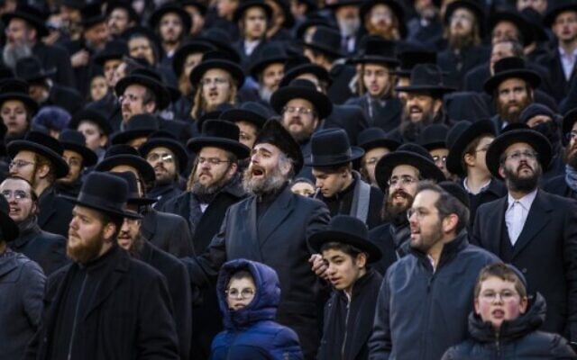 Orthodox Jews attend the 13th Siyum HaShas, a celebration marking the completion of the Daf Yomi, at the MetLife Stadium on January 1, 2020 in East Rutherford, New Jersey. Security was tightened at the event, where the Talmud is read in its entirety, after a rise in anti-Semitic incidents in the area.   (Eduardo Munoz Alvarez/Getty Images/AFP)