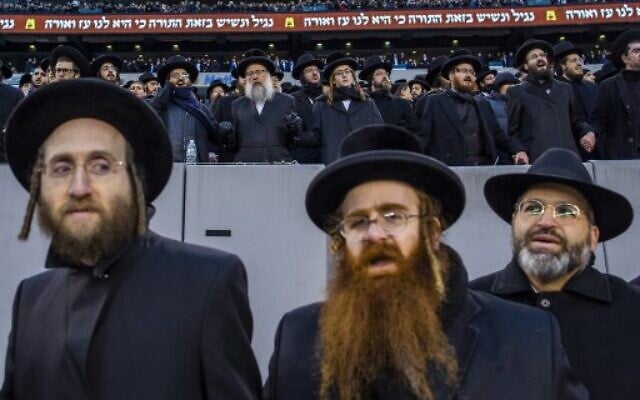 Orthodox Jews attend the 13th Siyum HaShas, a celebration marking the completion of the Daf Yomi, at the MetLife Stadium on January 1, 2020 in East Rutherford, New Jersey. Security was tightened at the event, where the Talmud is read in its entirety, after a rise in anti-Semitic incidents in the area.   (Eduardo Munoz Alvarez/Getty Images/AFP)