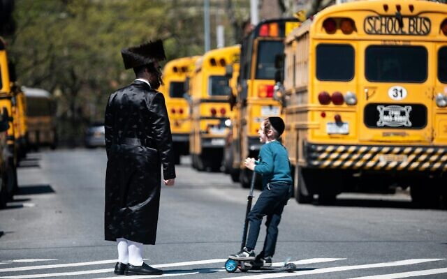 A Jewish man and a child stand on a street in the Williamsburg neighborhood of Brooklyn, April 24, 2019. (Johannes Eisele/AFP via Getty Images/ via JTA) A Jewish man and a child stand on a street in the Williamsburg neighborhood of Brooklyn, April 24, 2019. (Johannes Eisele/AFP via Getty Images/ via JTA)