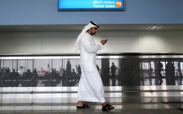 In this Oct. 27, 2013 file photo, a worker looks at his mobile phone at the newly opened Al Maktoum International Airport in Dubai, United Arab Emirates. (Patrick Castillo/Emarat Al Youm via AP, File) In this Oct. 27, 2013 file photo, a worker looks at his mobile phone at the newly opened Al Maktoum International Airport in Dubai, United Arab Emirates. (Patrick Castillo/Emarat Al Youm via AP, File)