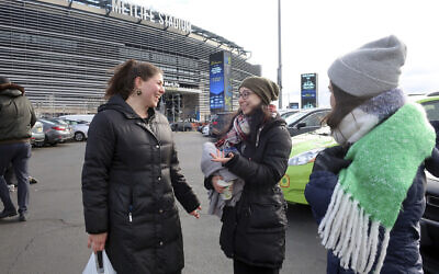 Rachel Leah Freilich and Rivka Lev of New York City talk before entering MetLife Stadium, Wednesday, Jan. 1, 2020, in East Rutherford, N.J., at an event called Siyum HaShas (AP Photo/Ted Shaffrey)