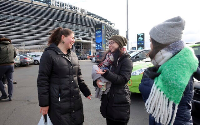 Rachel Leah Freilich and Rivka Lev of New York City talk before entering MetLife Stadium, Wednesday, Jan. 1, 2020, in East Rutherford, N.J., at an event called Siyum HaShas (AP Photo/Ted Shaffrey)