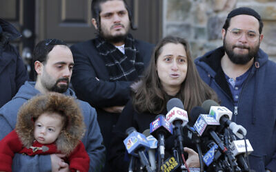 Surrounded primarily by family, Nicky Cohen, the daughter of Josef Neumann, who was critically injured in an attack on a Hanukkah celebration, speaks to reporters in front of her home in New City, New York, January 2, 2020. (AP Photo/Seth Wenig)