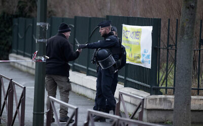A riot police officer checks a badge after a man attacked passerby January 3, 2020 in Villejuif, south of Paris. (AP Photo/Michel Euler)
