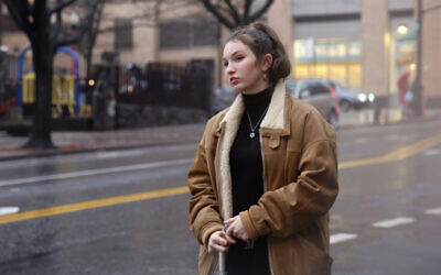 In this December 30, 2019, photo, Shoshana Blum, a 20-year-old junior at City College of New York, waits for a taxi in New York. (AP Photo/Emily Leshner)