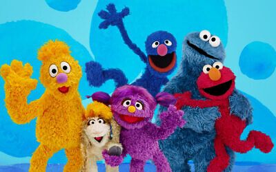From left, Jad, Ma'zooza, Basma, grover, background center, Cookie Monster and Elmo, characters in a new, locally produced Arabic TV program 'Welcome Sesame' for the hundreds of thousands of children dealing with displacement in Syria, Iraq, Jordan and Lebanon. (Sesame Workshop via AP)