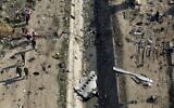 In this January 8, 2020, file photo, rescue workers search the scene where a Ukrainian plane crashed in Shahedshahr, southwest of Tehran, Iran. (AP Photo/Ebrahim Noroozi, File)