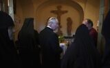 Britain's Prince Charles, center,  visits the tomb where his grandmother Princess Alice is buried at the Church of St Mary Magdalene at the Mount of Olives in Jerusalem, Israel, Friday, Jan. 2020. (Neil Hall/Pool Photo via AP)