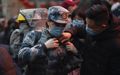 In this photo taken January 24, 2020 and released by Xinhua News Agency, a military medic from the Air Force Medical University prepares to leave for Wuhan from Xi'an, capital of northwestern China's Shaanxi Province.(Zhang Haopeng/Xinhua via AP) In this photo taken January 24, 2020 and released by Xinhua News Agency, a military medic from the Air Force Medical University prepares to leave for Wuhan from Xi'an, capital of northwestern China's Shaanxi Province.(Zhang Haopeng/Xinhua via AP)