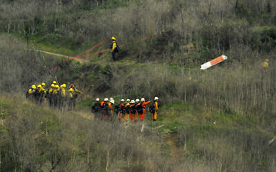 Firefighters work the scene of a helicopter crash where former NBA star Kobe Bryant died, January 26, 2020, in Calabasas, Calif. (AP Photo/Mark J. Terrill)