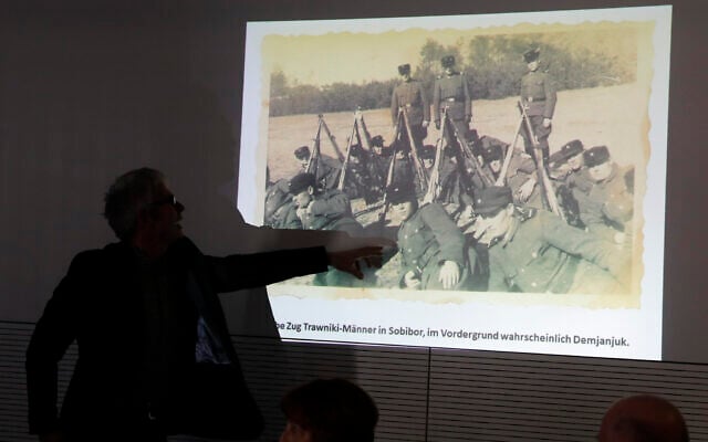 Historican Martin Cueppers points at a man, presumably former security guard John Demjanjuk, at the Nazi death camp Sobibor during a news conference of newly discovered photos from the Sobibor camp in Berlin, Germany, January 28, 2020. (AP Photo/Markus Schreiber) Historican Martin Cueppers points at a man, presumably former security guard John Demjanjuk, at the Nazi death camp Sobibor during a news conference of newly discovered photos from the Sobibor camp in Berlin, Germany, January 28, 2020. (AP Photo/Markus Schreiber)