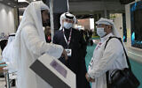 Visitors and exhibitors wear masks at the Arab Health Exhibition in Dubai, United Arab Emirates, January 29, 2020. (AP Photo/Kamran Jebreili)