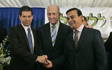Then prime minister Ehud Olmert, center, shakes hands with Israeli investor Shai Agassi, left, and Carlos Ghosn at the Prime Minister's office in Jerusalem, January 21, 2008. (AP Photo/Sebastian Scheiner)