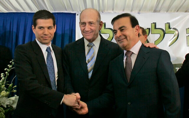 Then prime minister Ehud Olmert, center, shakes hands with Israeli investor Shai Agassi, left, and Carlos Ghosn at the Prime Minister's office in Jerusalem, January 21, 2008. (AP Photo/Sebastian Scheiner) Then prime minister Ehud Olmert, center, shakes hands with Israeli investor Shai Agassi, left, and Carlos Ghosn at the Prime Minister's office in Jerusalem, January 21, 2008. (AP Photo/Sebastian Scheiner)
