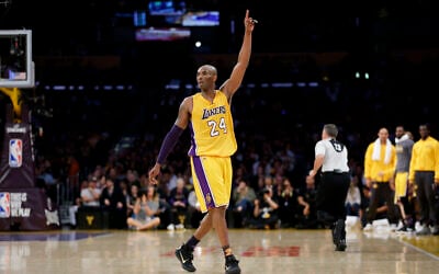 Los Angeles Lakers forward Kobe Bryant gestures during the first half of his last NBA basketball game, against the Utah Jazz, on April 13, 2016, in Los Angeles. (AP Photo/Jae C. Hong)