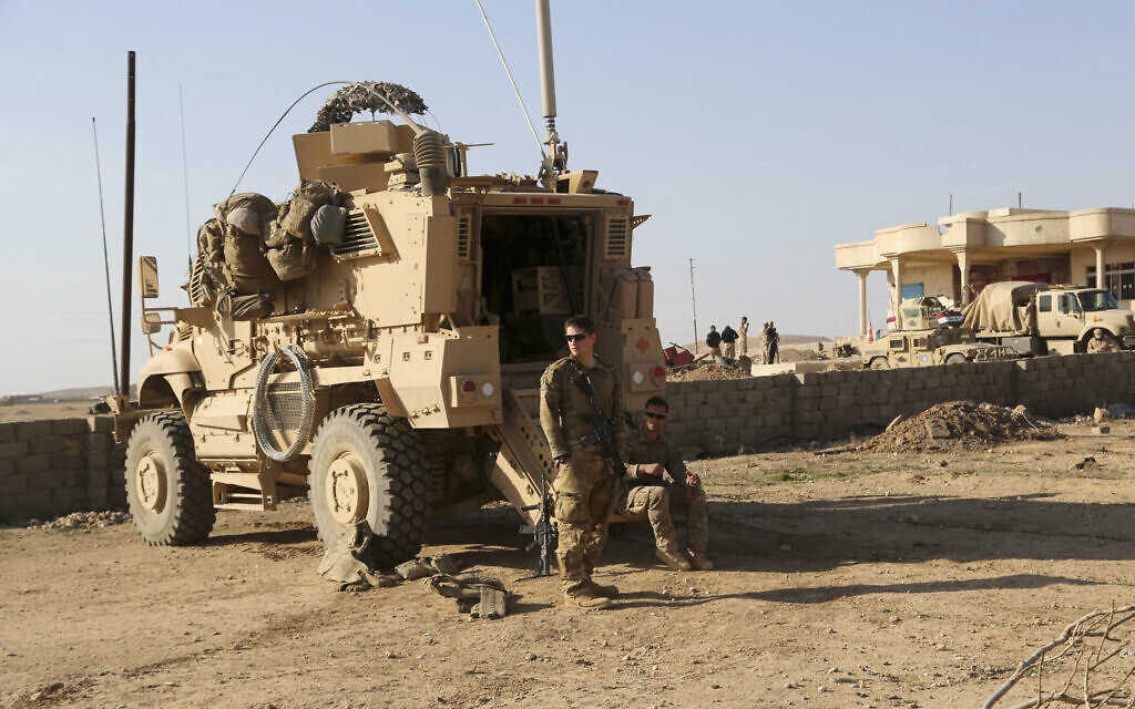 US Army soldiers stand outside their armored vehicle on a joint base with Iraqi army south of Mosul, Iraq, February 23, 2017. (Khalid Mohammed/AP/File) US Army soldiers stand outside their armored vehicle on a joint base with Iraqi army south of Mosul, Iraq, February 23, 2017. (Khalid Mohammed/AP/File)