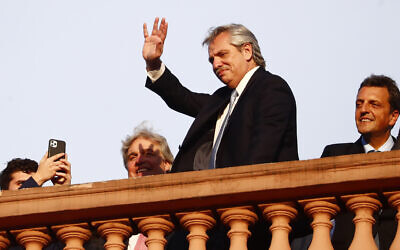 Argentina's President Alberto Fernandez waves to supporters from the terrace of the presidential palace in Buenos Aires, Argentina, December 10, 2019. (AP Photo/Marcos Brindicci)