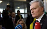 Lithuanian President Gitanas Nauseda speaks with the media as he arrives for an EU summit in Brussels, December 12, 2019. (AP Photo/Olivier Matthys)