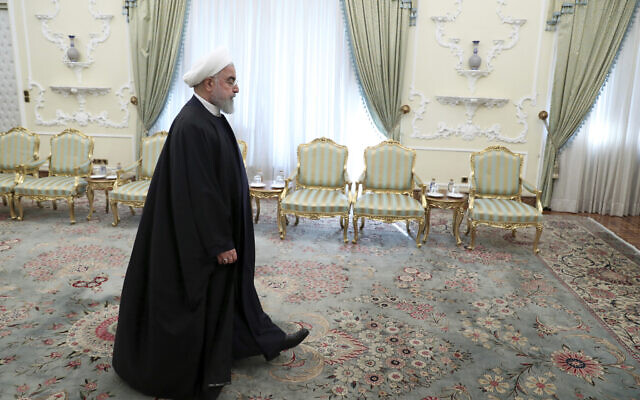 Iranian President Hassan Rouhani arrives for a meeting at the presidency office in Tehran, Iran, December 23, 2019. (Ebrahim Noroozi/AP) Iranian President Hassan Rouhani arrives for a meeting at the presidency office in Tehran, Iran, December 23, 2019. (Ebrahim Noroozi/AP)