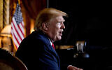 In this Dec. 24, 2019 photo, President Donald Trump speaks to members of the media following a Christmas Eve video teleconference with members of the military at his Mar-a-Lago estate in Palm Beach, Fla.  (AP Photo/Andrew Harnik)