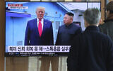 People watch a TV screen showing a file image of North Korean leader Kim Jong Un and US President Donald Trump, left, during a news program at the Seoul Railway Station in Seoul, South Korea, Tuesday, Dec. 31, 2019. (AP Photo/Ahn Young-joon)