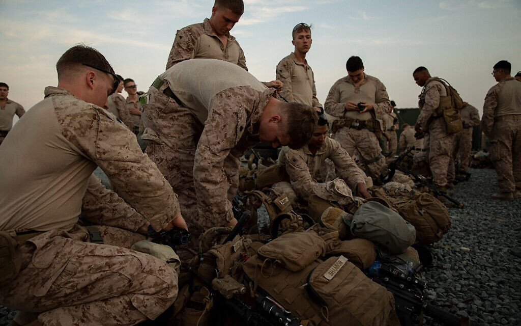In this photo provided by U.S. Department of Defense, U.S. Marines assigned to Special Purpose Marine Air-Ground Task Force-Crisis Response-Central Command (SPMAGTF-CR-CC) 19.2, prepare to deploy from Kuwait in support of a crisis response mission, Tuesday, Dec. 31, 2019. (U.S. Marine Corps photos by Sgt. Robert G. Gavaldon via AP) In this photo provided by U.S. Department of Defense, U.S. Marines assigned to Special Purpose Marine Air-Ground Task Force-Crisis Response-Central Command (SPMAGTF-CR-CC) 19.2, prepare to deploy from Kuwait in support of a crisis response mission, Tuesday, Dec. 31, 2019. (U.S. Marine Corps photos by Sgt. Robert G. Gavaldon via AP)