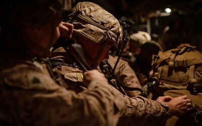 In this photo provided by US Department of Defense, US Marines assigned to Special Purpose Marine Air-Ground Task Force-Crisis Response-Central Command (SPMAGTF-CR-CC) 19.2, prepare to deploy from Kuwait in support of a crisis response mission, Tuesday, Dec. 31, 2019. (US Marine Corps photos by Sgt. Robert G. Gavaldon via AP)