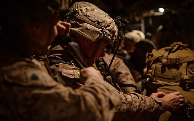 In this photo provided by US Department of Defense, US Marines assigned to Special Purpose Marine Air-Ground Task Force-Crisis Response-Central Command (SPMAGTF-CR-CC) 19.2, prepare to deploy from Kuwait in support of a crisis response mission, Tuesday, Dec. 31, 2019. (US Marine Corps photos by Sgt. Robert G. Gavaldon via AP) In this photo provided by US Department of Defense, US Marines assigned to Special Purpose Marine Air-Ground Task Force-Crisis Response-Central Command (SPMAGTF-CR-CC) 19.2, prepare to deploy from Kuwait in support of a crisis response mission, Tuesday, Dec. 31, 2019. (US Marine Corps photos by Sgt. Robert G. Gavaldon via AP)