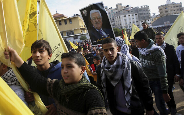 Palestinian Fatah supporters hold a portrait of Palestinian Authority President Mahmoud Abbas during a celebration marking the 55th anniversary of the Fatah movement, in Gaza City, Wednesday, Jan. 1, 2020. (AP Photo/Adel Hana) Palestinian Fatah supporters hold a portrait of Palestinian Authority President Mahmoud Abbas during a celebration marking the 55th anniversary of the Fatah movement, in Gaza City, Wednesday, Jan. 1, 2020. (AP Photo/Adel Hana)