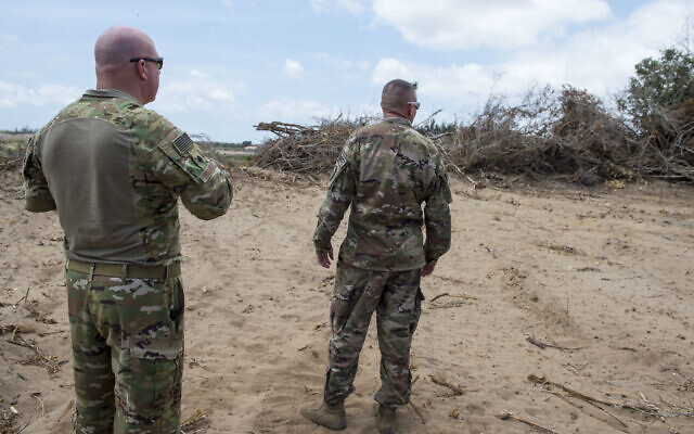 In this photo taken February 24, 2018 and released by the US Air Force, US servicemen look at trees that are being cleared during a battlefield circulation site visit at Camp Simba, Manda Bay, Kenya. (Staff Sgt. Timothy Moore/U.S. Air Force via AP) In this photo taken February 24, 2018 and released by the US Air Force, US servicemen look at trees that are being cleared during a battlefield circulation site visit at Camp Simba, Manda Bay, Kenya. (Staff Sgt. Timothy Moore/U.S. Air Force via AP)