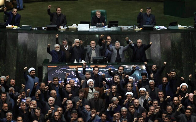 Iranian lawmakers chant anti-American and anti-Israeli slogans to protest against the US killing of Iranian top general Qassem Soleimani, at the start of an open session of parliament in Tehran, Iran, January 5, 2020. (Mohammad Hassanzadeh/Tasnim News Agency via AP) Iranian lawmakers chant anti-American and anti-Israeli slogans to protest against the US killing of Iranian top general Qassem Soleimani, at the start of an open session of parliament in Tehran, Iran, January 5, 2020. (Mohammad Hassanzadeh/Tasnim News Agency via AP)