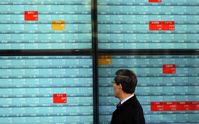 A man looks at an electronic stock board showing Japan's Nikkei 225 index at a securities firm in Tokyo, January 6, 2020, in Tokyo, marking the start of this year's trading (AP Photo/Eugene Hoshiko) A man looks at an electronic stock board showing Japan's Nikkei 225 index at a securities firm in Tokyo, January 6, 2020, in Tokyo, marking the start of this year's trading (AP Photo/Eugene Hoshiko)