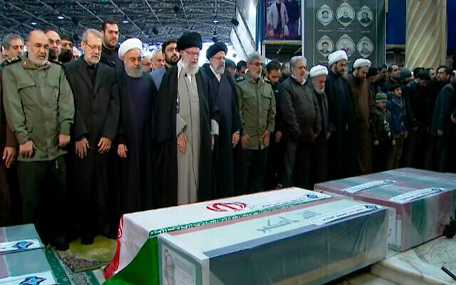 In this photo released by the official website of the Office of the Iranian Supreme Leader, supreme leader Ayatollah Ali Khamenei, fourth from left, leads a prayer over the coffins of Gen. Qassem Soleimani and his comrades, who were killed in Iraq in a US drone strike on Friday, at the Tehran University campus, in Tehran, Iran, Jan. 6, 2020. (Office of the Iranian Supreme Leader via AP)