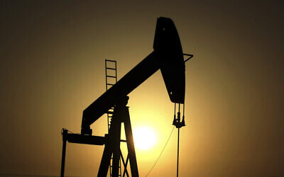 In this June 8, 2011 file photo, sun sets behind an oil pump in the desert oil fields of Sakhir, Bahrain (AP Photo/Hasan Jamali, File)