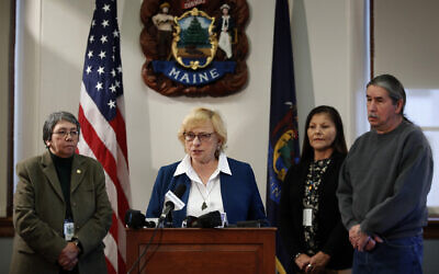 Maine Gov. Janet Mills speaks to reporters before signing papers to posthumously pardon Don Gellers, a Passamaquoddy tribal lawyer convicted of marijuana possession, Tuesday, Jan. 7, 2020 at the Statehouse in Augusta, Maine. Accompanying the governor, from left, is Donna Loring, the governor's senior adviser on tribal affairs, Tribal Rep. Rena Newell, and Darrell Newell, Vice Chief of the Passamaquoddy Indian Township. (AP Photo/Robert F. Bukaty)