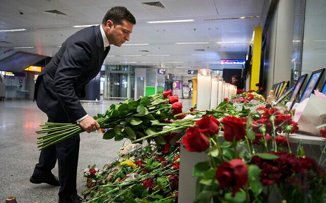 Ukrainian President Volodymyr Zelensky lays flowers at a memorial of the flight crew members of the Ukrainian 737-800 plane that crashed on the outskirts of Tehran, at Borispil international airport outside in Kyiv, Ukraine, January 9, 2020. (Ukrainian Presidential Press Office via AP) Ukrainian President Volodymyr Zelensky lays flowers at a memorial of the flight crew members of the Ukrainian 737-800 plane that crashed on the outskirts of Tehran, at Borispil international airport outside in Kyiv, Ukraine, January 9, 2020. (Ukrainian Presidential Press Office via AP)