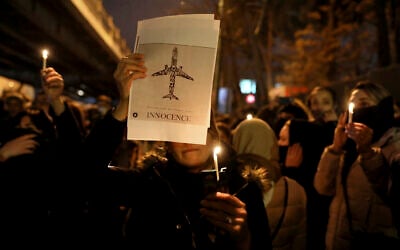 People gather for a candlelight vigil to remember the victims of the Ukraine plane crash, at the gate of Amri Kabir University where some of the victims of the crash were former students, in Tehran, Iran, January 11, 2020. (AP/Ebrahim Noroozi)