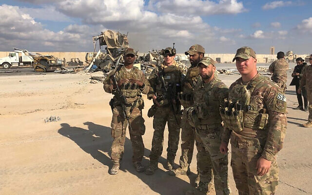 US soldiers stand at a site of Iranian bombing at Ain al-Asad air base in Anbar, Iraq, January 13, 2020. (AP Photo/Qassim Abdul-Zahra) US soldiers stand at a site of Iranian bombing at Ain al-Asad air base in Anbar, Iraq, January 13, 2020. (AP Photo/Qassim Abdul-Zahra)