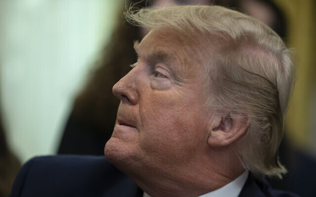 US President Donald Trump listens during an event on prayer in public schools, in the Oval Office of the White House, in Washington, January 16, 2020. ( Evan Vucci/AP) US President Donald Trump listens during an event on prayer in public schools, in the Oval Office of the White House, in Washington, January 16, 2020. ( Evan Vucci/AP)