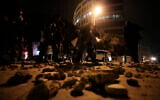 Lebanese police walk after dispersing a protest in Beirut, Lebanon, January 18, 2020. (AP/Hassan Ammar)