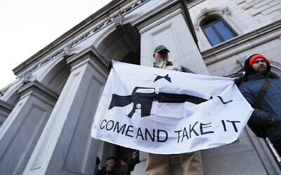 A demonstrator stands outside a court house during a pro-gun rally, Monday, Jan. 20, 2020, in Richmond, Va. (AP/Julio Cortez)