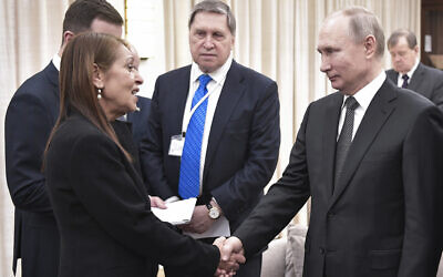 Russian President Vladimir Putin, right, shakes hands with Yaffa Issachar, mother of Israeli citizen Naama Issachar who is jailed in Russia for a drugs offense in Jerusalem, Jan. 23, 2020 (Aleksey Nikolskyi, Sputnik Kremlin Pool Photo via AP)