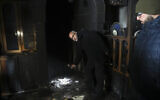 Palestinians visit a torched mosque in the Arab neighborhood of Sharafat in East Jerusalem on January 24, 2020 (AP Photo/Mahmoud Illean)